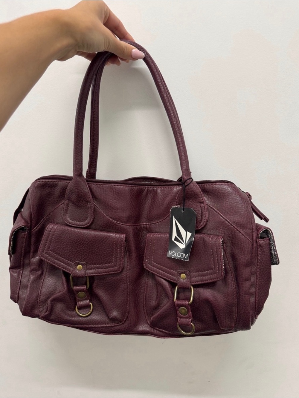 Volcom Burgundy Duffel Bag with Patterned Gray-White Interior. New with stains.